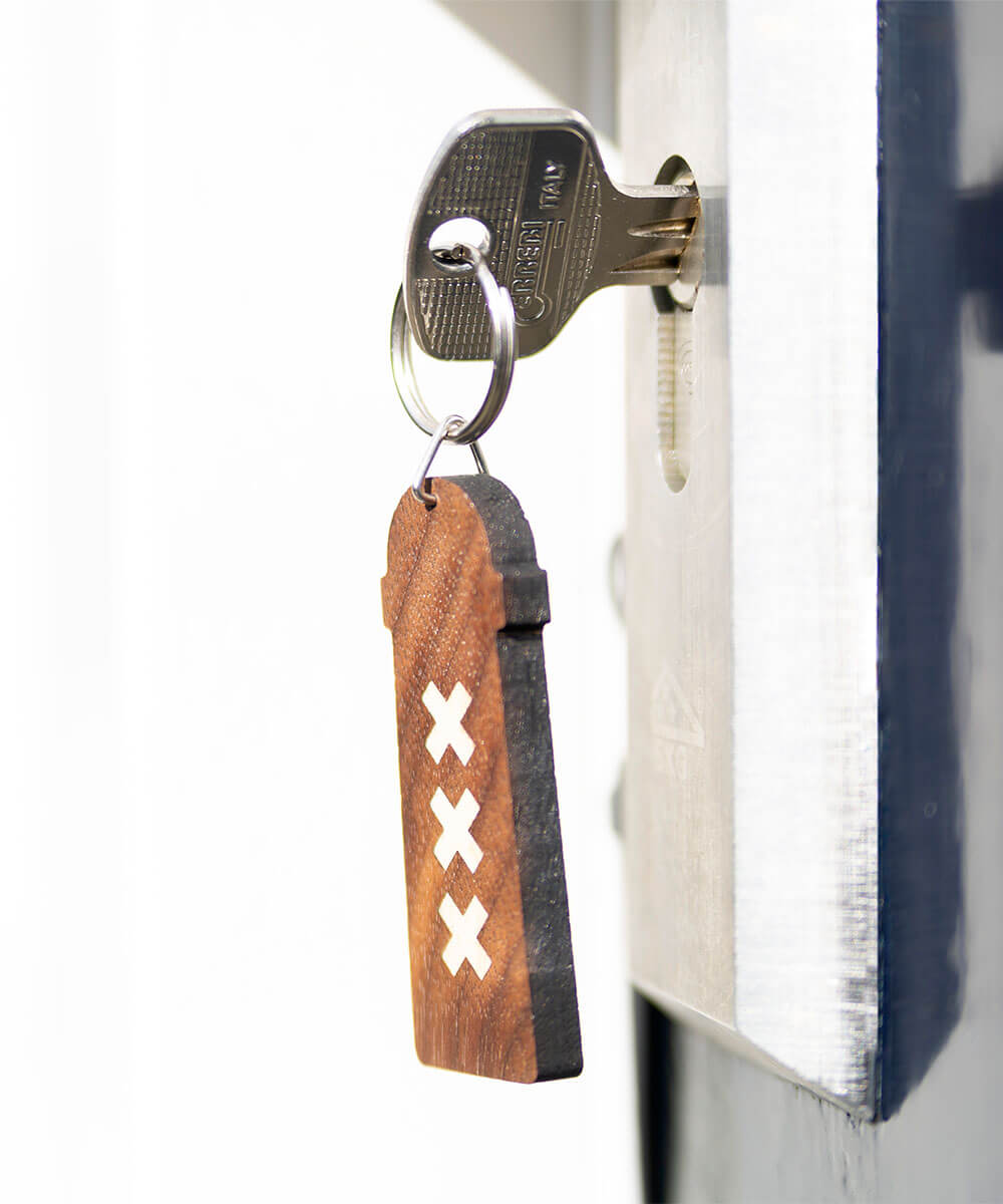 wooden keychain amsterdammertje with key in lock on webshop wooden amsterdam.jpg