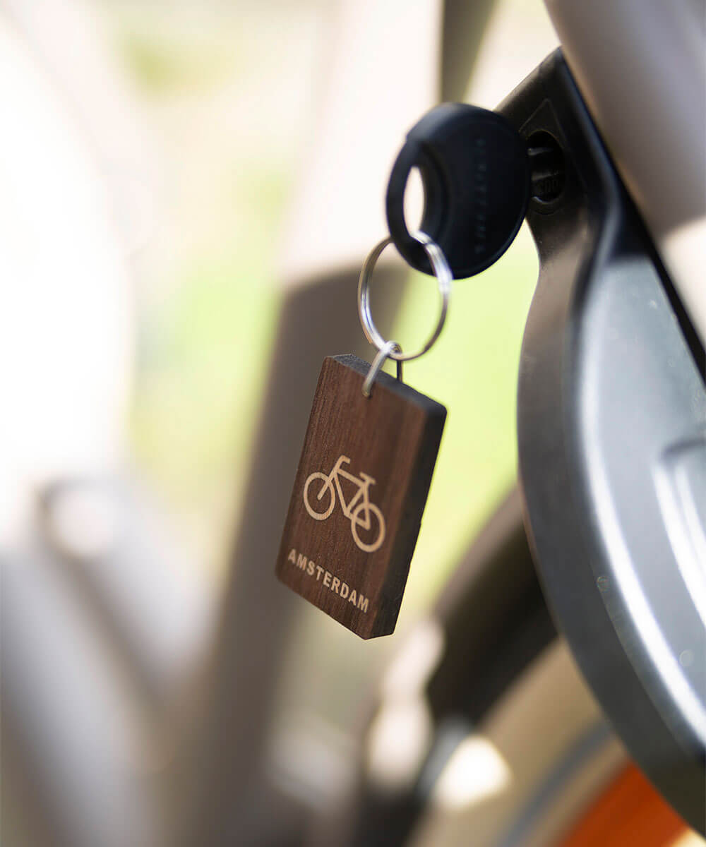 wooden keychain bicycle with key in lock on webshop wooden amsterdam.jpg